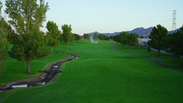 view down the fairway with scenic mountains in the background